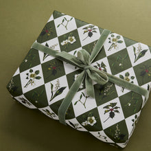 Load image into Gallery viewer, Gift wrapped in green and white patterned paper with a green ribbon on a matching background